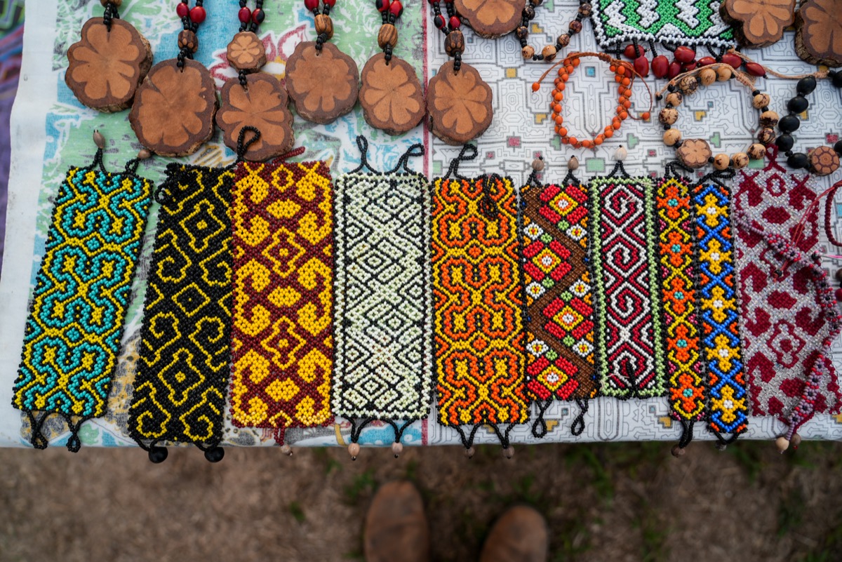 Kené-patterned beaded bracelets and wooden pendants by Ida Castro Rojas, Shipibo-Konibo artisanry, Paohyan, Peru