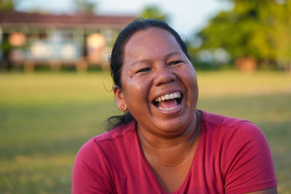 Ida Castro Rojas (Pekonkaisy), Shipibo-Konibo artisan and bilingual teacher, laughing outdoors in Paohyan, Peru